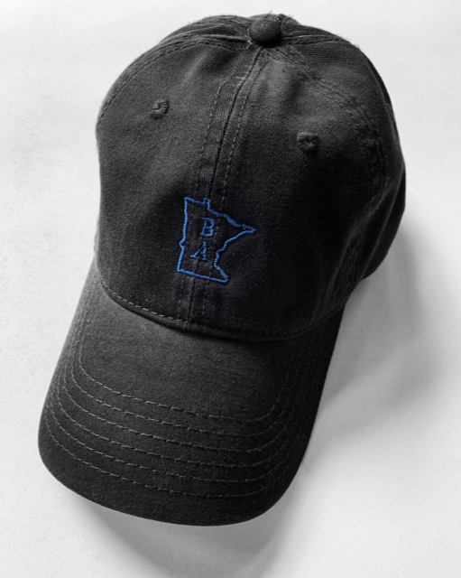Black cotton hat with blue BA Minnesota logo on the front. Black and Blue Dad Hat is designed and sold by Craftmade Aprons.