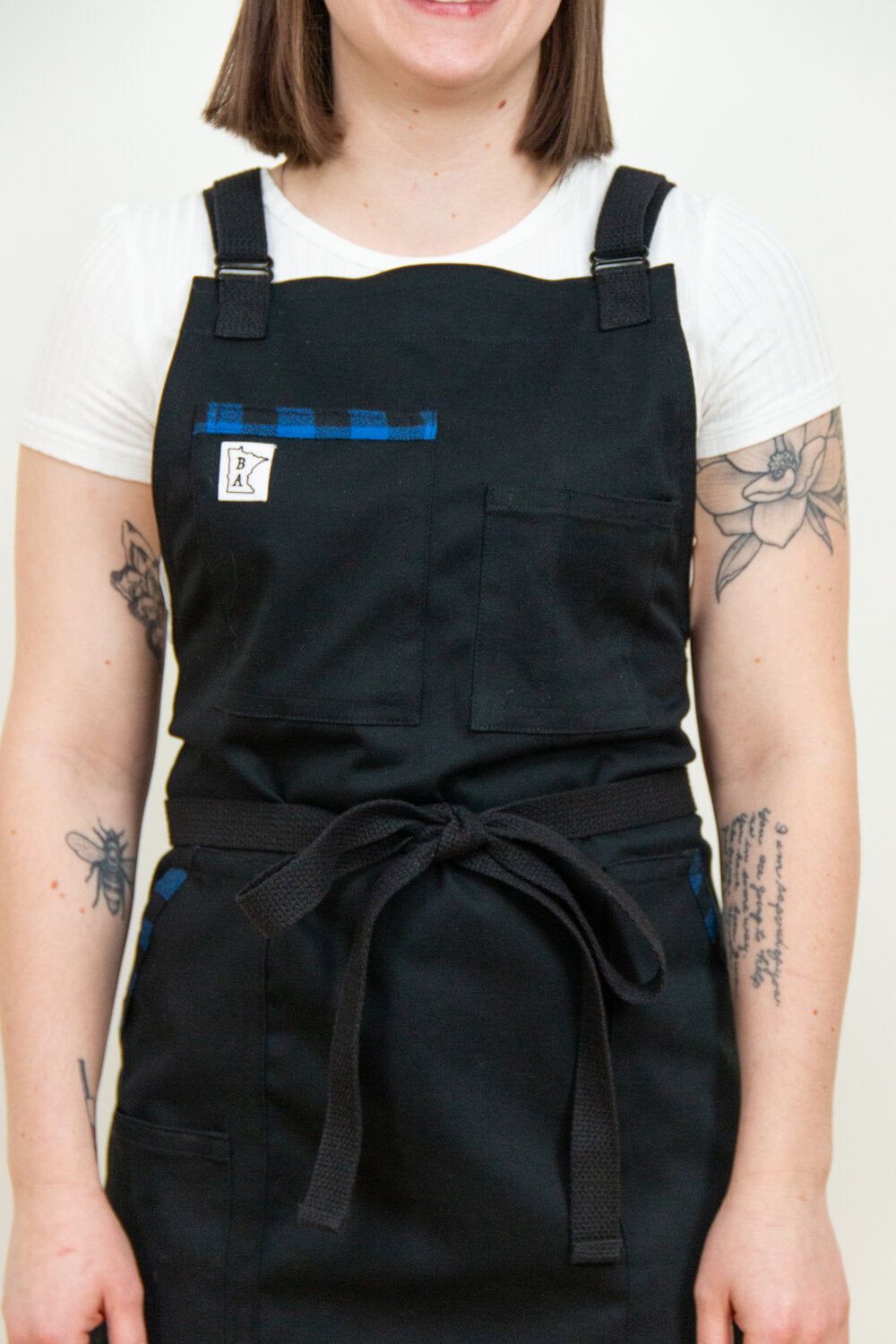 Cotton apron, Black and Blue II, displayed on Emma. Blue flannel accents designed by Craftmade Aprons based in Minnesota.