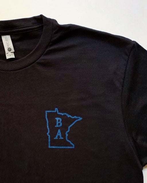 This black cotton T-shirt is the official T-shirt of Project Black and Blue. BA Minnesota logo located on the left chest area. Designed by Craftamade Aprons in Minnesota.